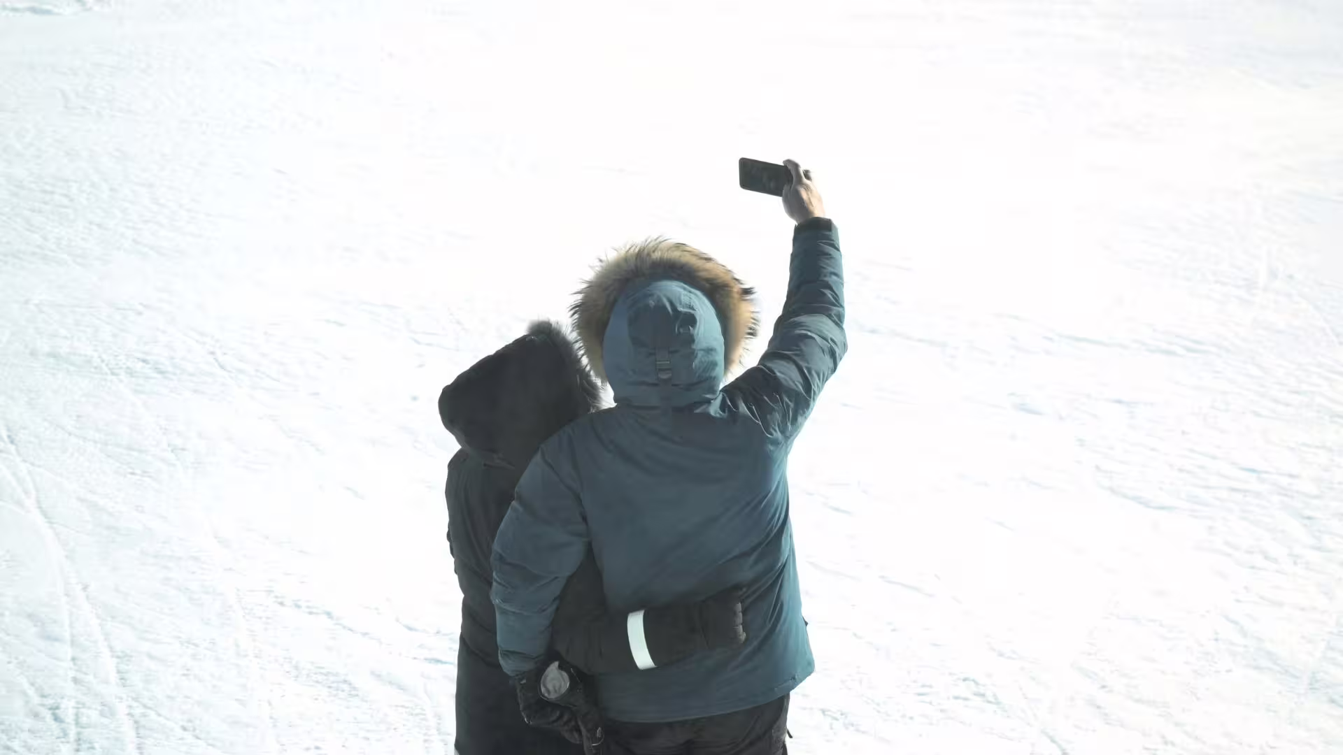 Couple takes selfie on Langjökull glacier during Ice Cave and Glacier Monster Truck tour departing from Gullfoss