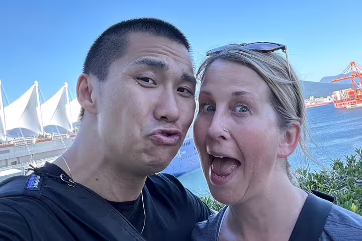 Couple selfie with Canada Place and harbor views, starting Vancouver Gastown scavenger hunt experience