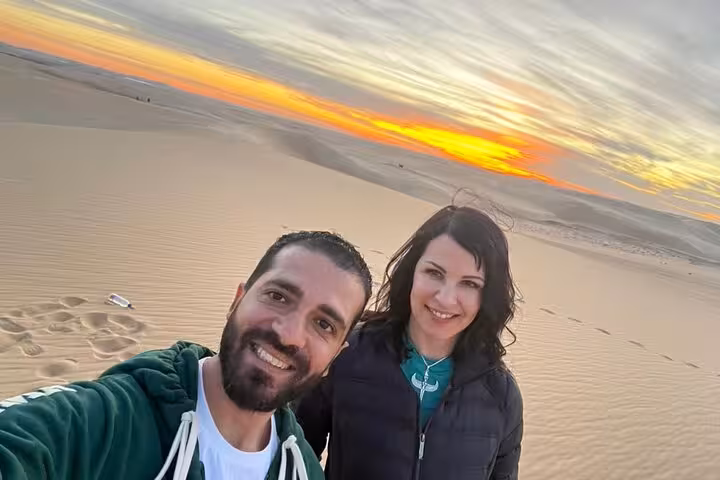 Couple selfie at sunset on Siwa Sahara dunes, Egypt, during a private 3-day desert safari adventure