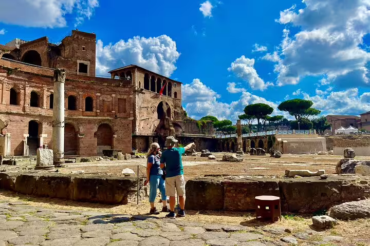Couple exploring ancient ruins at Trajan Markets in Rome with private guide, enjoying a skip-the-line Imperial Forum walking tour