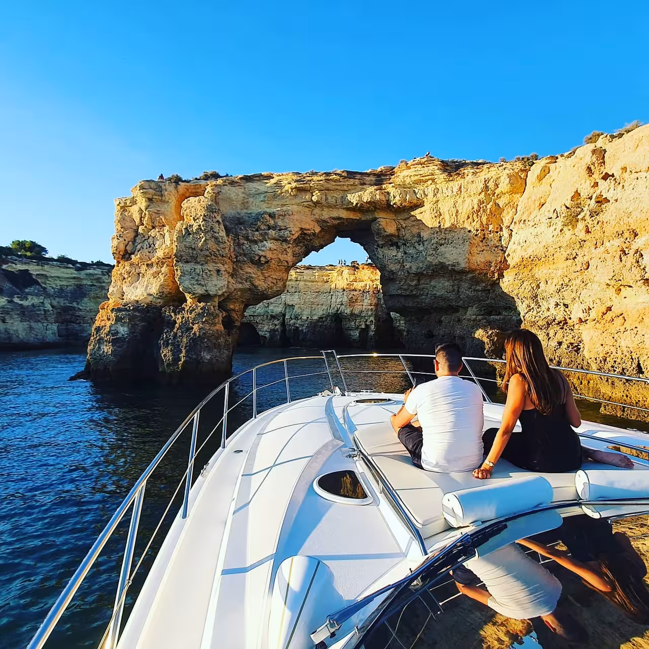 Couple on yacht approaching Algarve sea arch and caves on Full Day Cruise Silver 8-hour coastal cruise