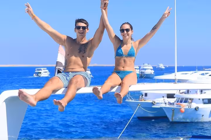 Couple celebrating on a yacht in Sharm El-Sheikh, heading to Ras Mohamed and White Island snorkeling