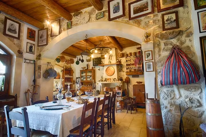 Rustic Cretan taverna dining room set for a Cretan Night tour dinner with local food, wine and live music