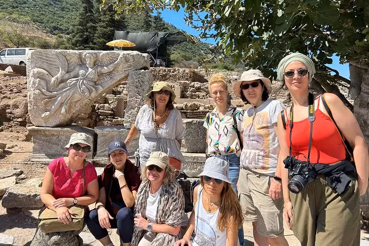 Cruise guests on private Ephesus tour pose by ancient stone relief, Kusadasi shore excursion skip-the-line
