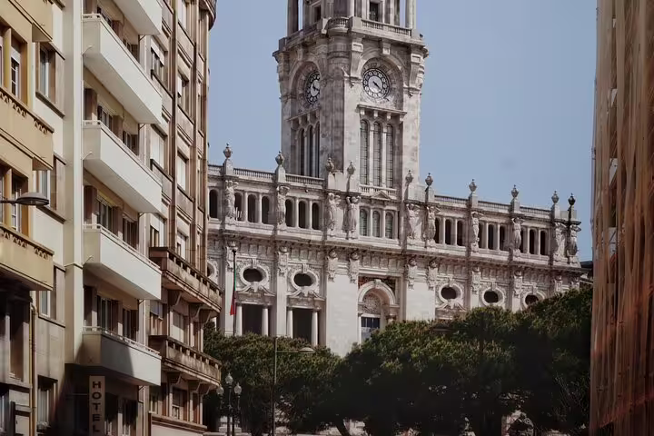 Historic city center with a grand clock tower viewed from a street, ideal for a private tuk-tuk tour on a cruise shore excursion.