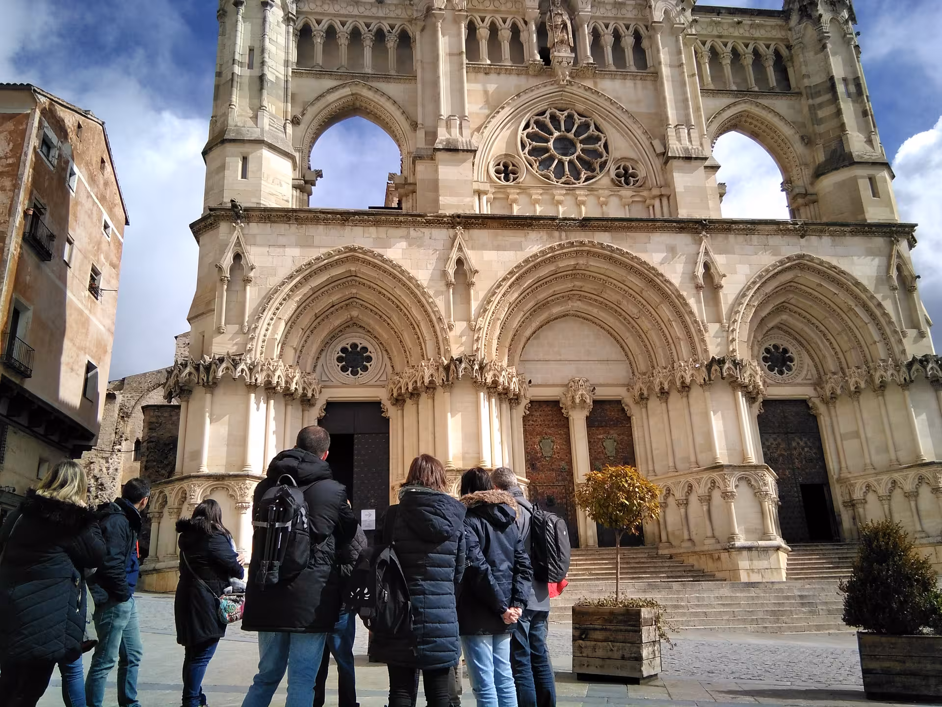 Travelers visiting Cuenca Cathedral facade on a day tour from Madrid, including entry tickets and guide