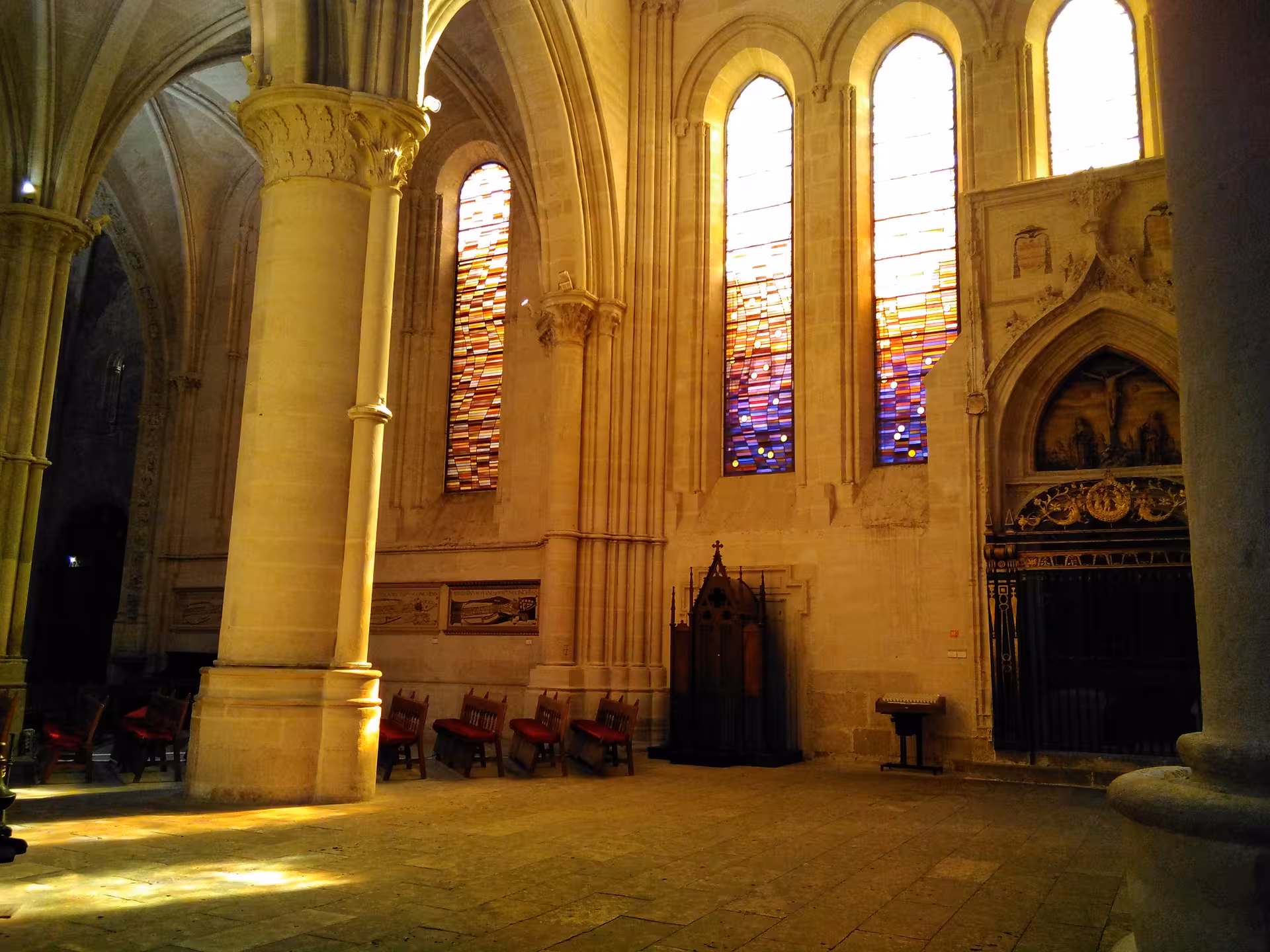 Sunlit nave with stained-glass windows in Cuenca Cathedral, a highlight of the Madrid to Cuenca excursion