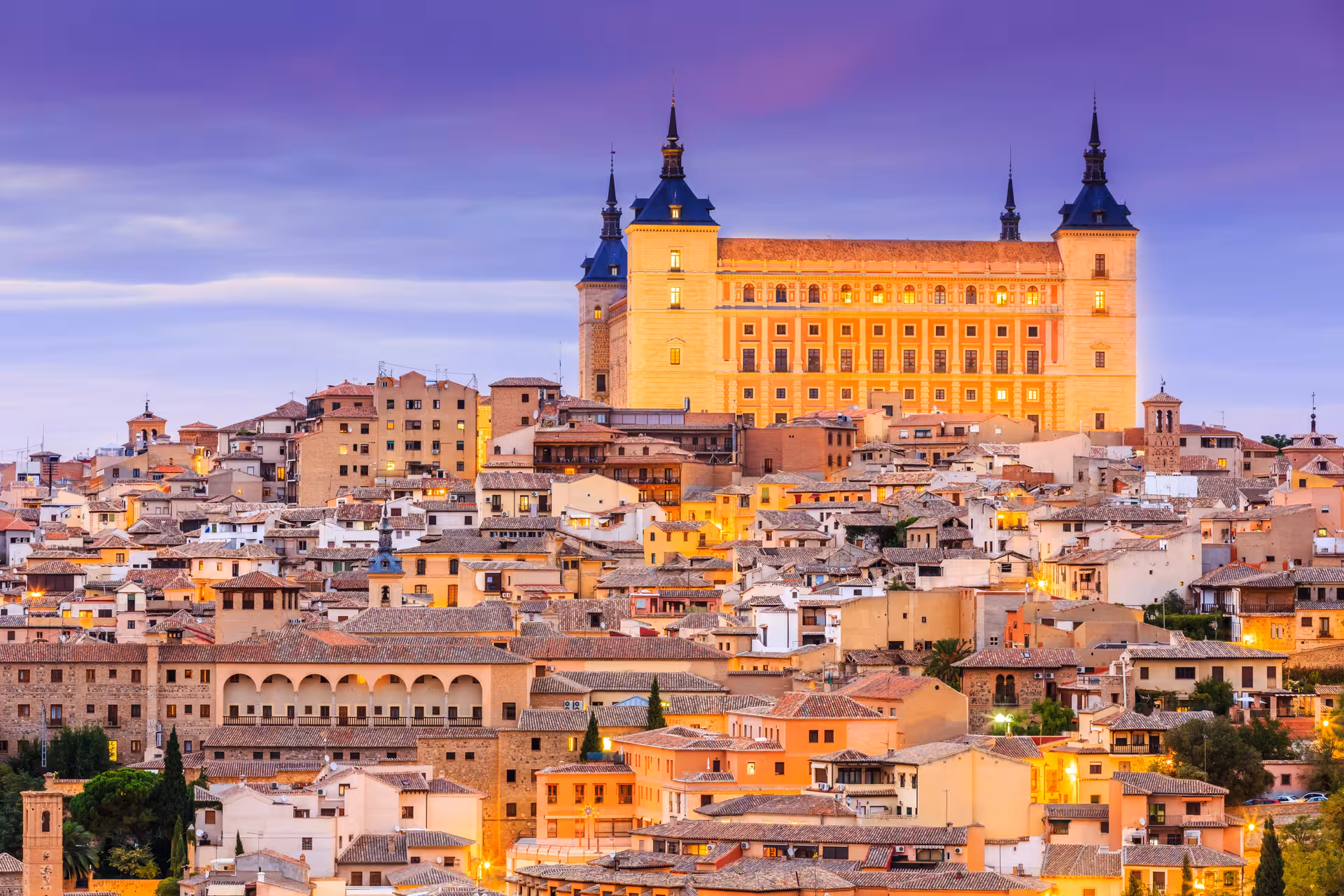 Day trip from Madrid to Cuenca featuring the Hanging Houses and historic old town skyline at sunset
