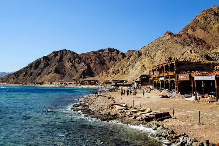Rocky Dahab shore and seaside camps by the Red Sea, photo from Dahab day tour from Sharm with snorkeling and quad biking