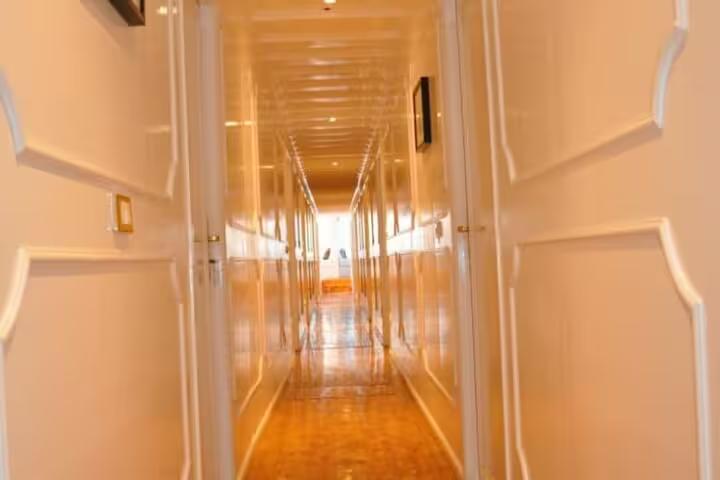Interior corridor of a dahabiya Nile cruise with cabin doors, comfort onboard 5 days 4 nights Nile sailing tour