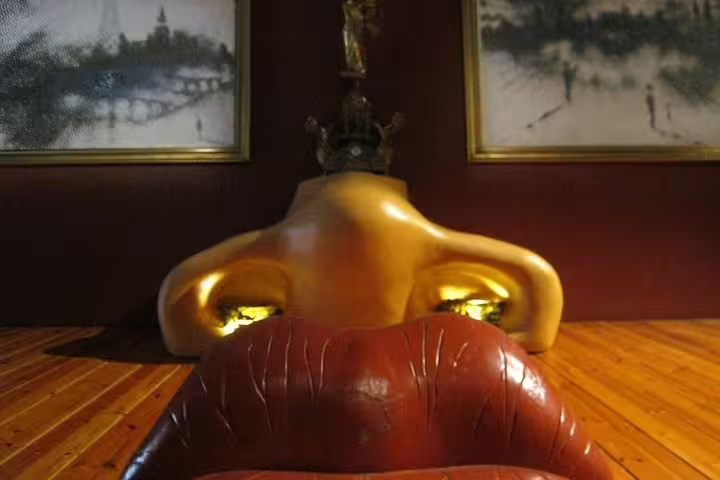 Explore Dalí Museum's surreal art installation featuring a sofa resembling lips and a sculptural nose.