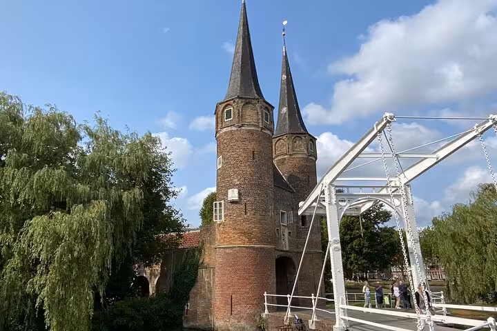 Delft East Gate and canal bridge, a highlight on private tour from Rotterdam to Kinderdijk and The Hague