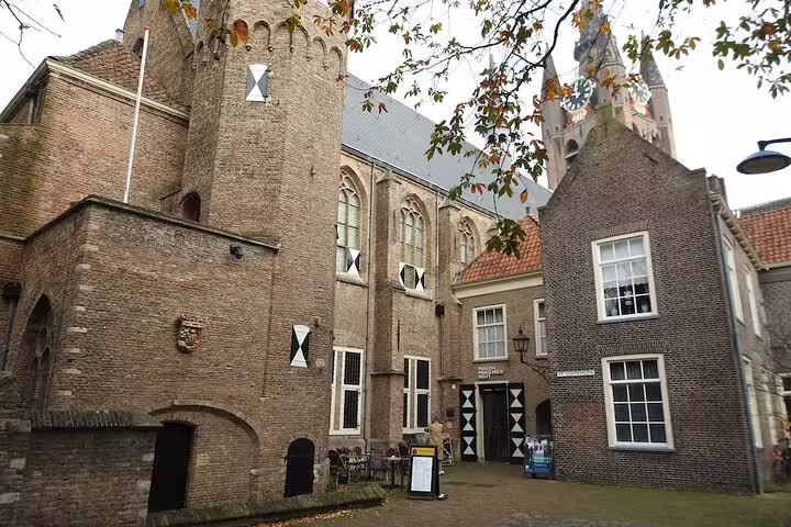Delft old town courtyard and church towers on a self-guided highlights walking tour with audio and GPS