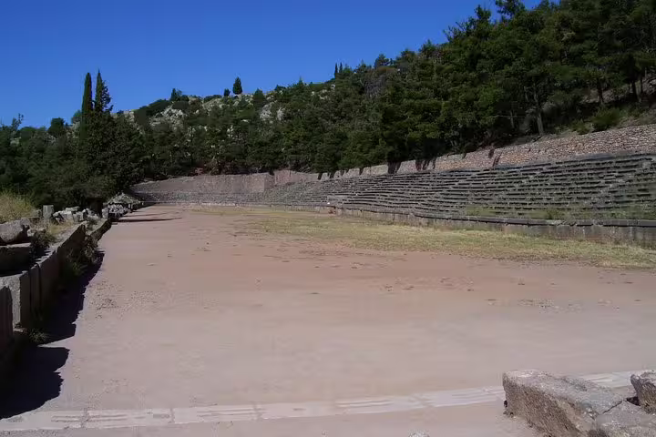 Ancient stadium at Delphi with stone seating and mountain views on Delphi and Meteora 2-day private tour