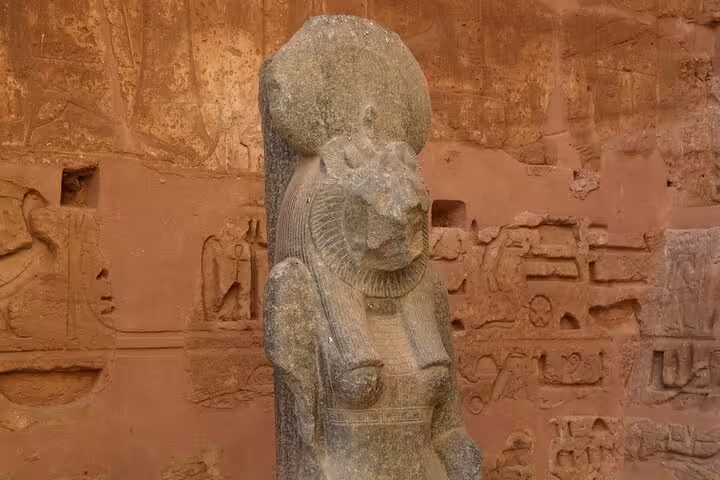 Ancient Egyptian statue and wall reliefs at Medinet Habu, Luxor, on a Dendera and Medinet Habu tour