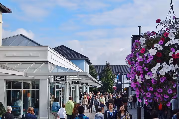 Busy Designer Outlet Roermond shopping street on private day trip from Amsterdam with luxury brand stores