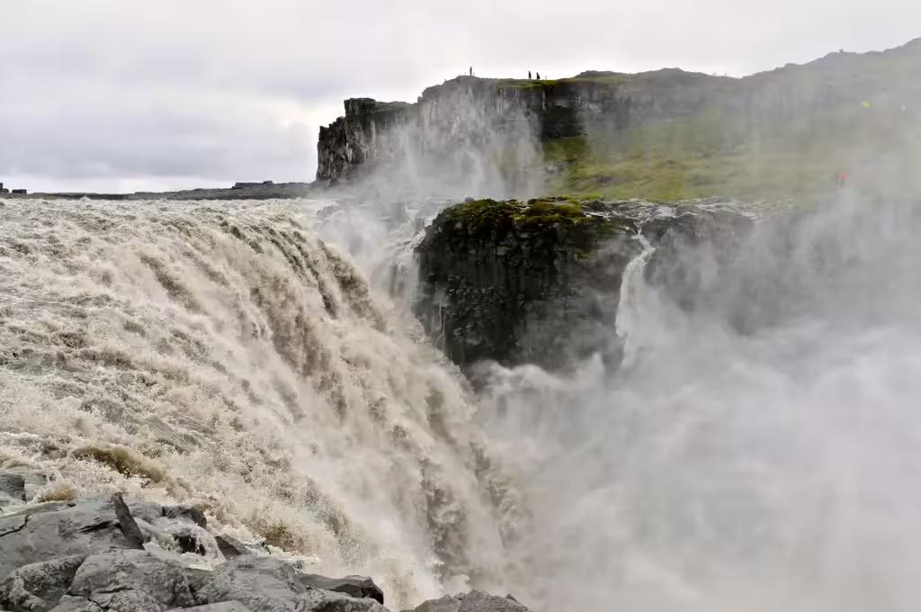Powerful Dettifoss waterfall cascading over basalt cliffs with mist rising, Diamond Circle Iceland
