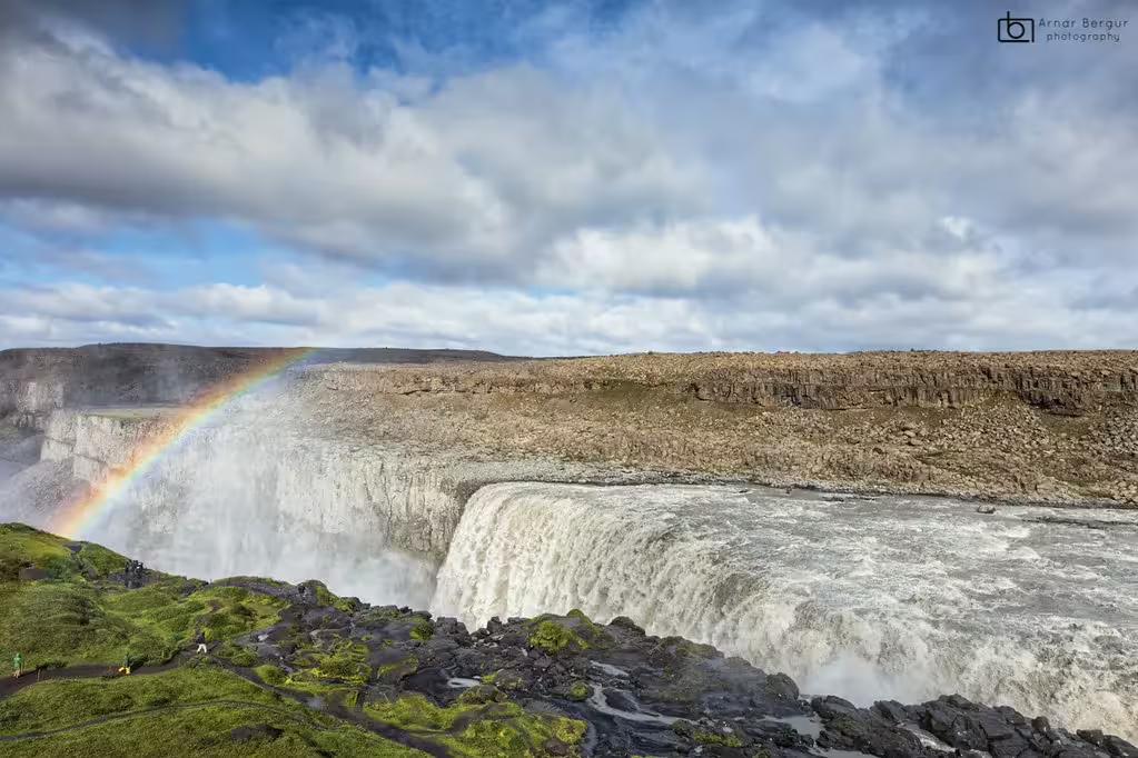 Dettifoss waterfall with rainbow and misty spray on Diamond Circle tour from Akureyri, Iceland