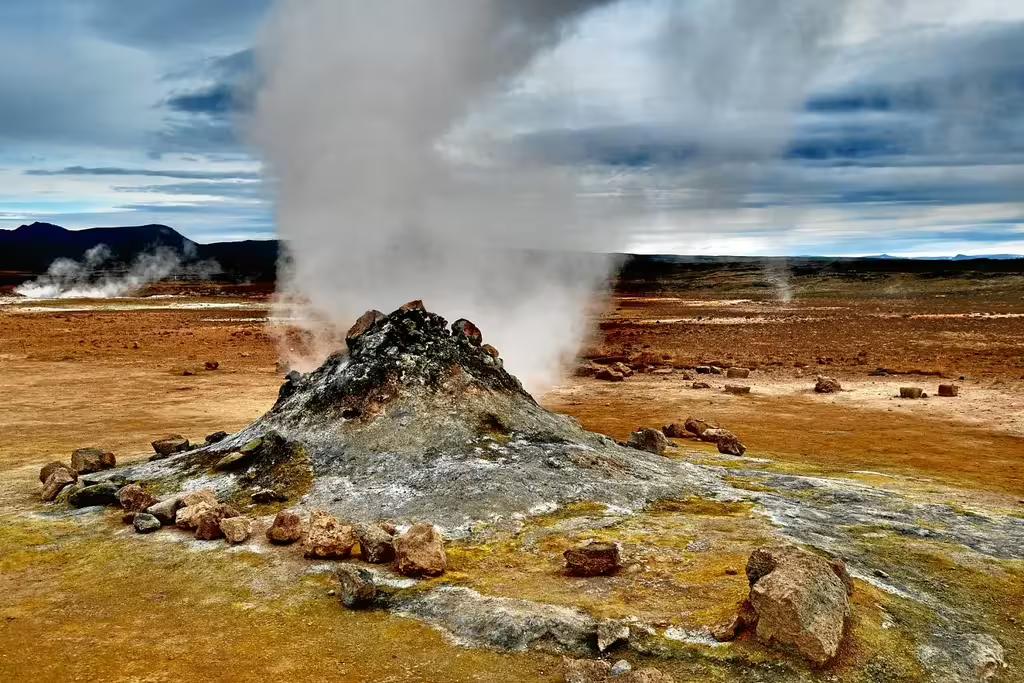 Steaming geothermal mud pot with sulfur deposits on the Diamond Circle, Iceland