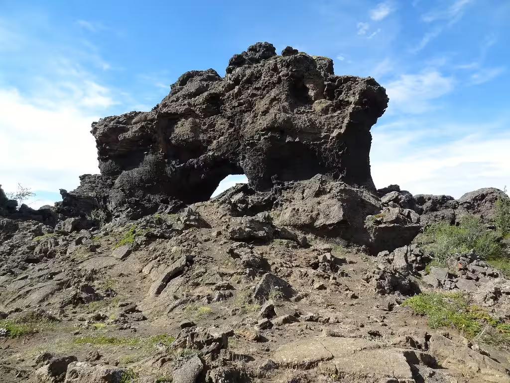 Dramatic volcanic lava rock formation with natural arch at Dimmuborgir near Lake Mývatn, Iceland
