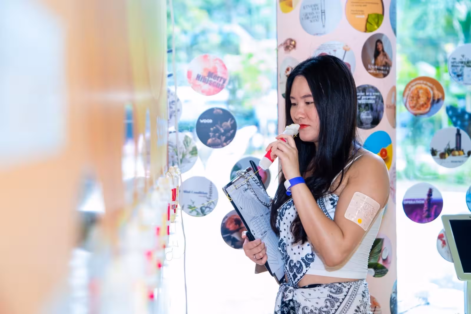 Woman engaged in scent selection during DIY perfume making experience at Sentosa, Singapore.