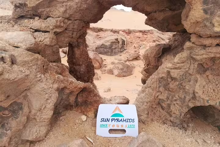 Natural rock arch in Egypt Black Desert, stop on 5-day Djara Cave and White Desert safari with desert camping