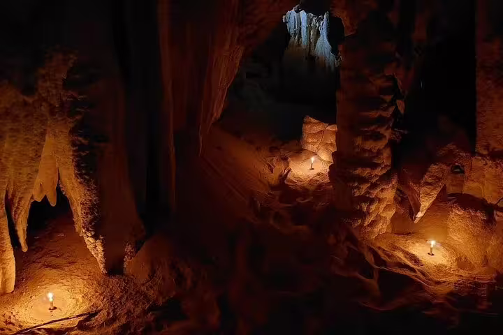 Candlelit passage inside Djara Cave, atmospheric underground scene on 5-day Egypt desert camping safari