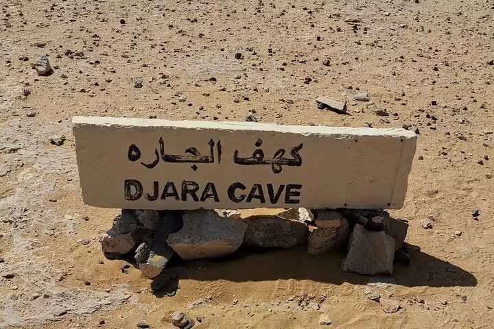 Djara Cave sign in Egypt desert, key stop on 5-day Djara Cave, Black and White Desert camping package