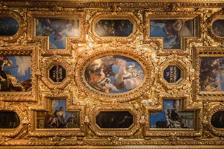 Marvel at the intricate golden ceiling artwork in Doge's Palace, featured in our skip-the-line guided tour.
