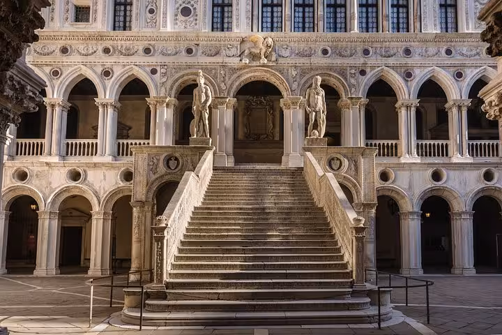 The majestic Scala dei Giganti staircase in Doge's Palace courtyard, showcasing Renaissance architecture and sculptures.