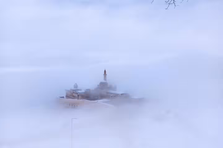 Fog-covered Dogubeyazit mosque silhouette at dawn, atmospheric view on all-inclusive private guided 3-day tour