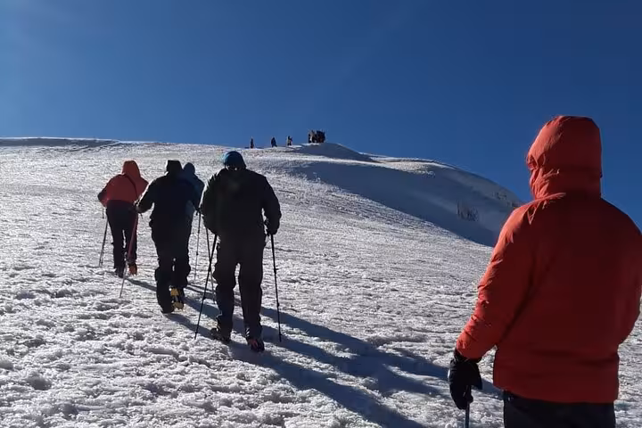 Winter trek near Dogubeyazit with guide, hikers climbing snowy slope on a 3-day all-inclusive tour