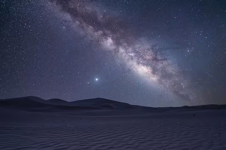 Stunning Milky Way view over Doha's desert, ideal for night safari and camel ride seekers.