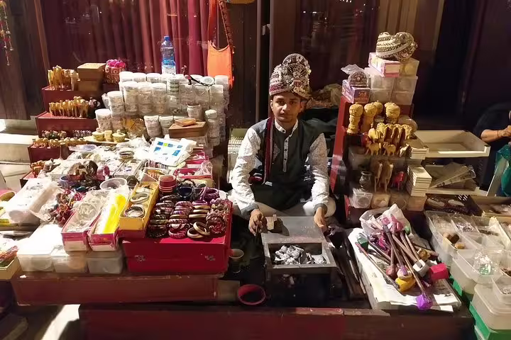 Vendor selling traditional crafts at a vibrant market stall in Doha, showcasing local culture and handmade goods.