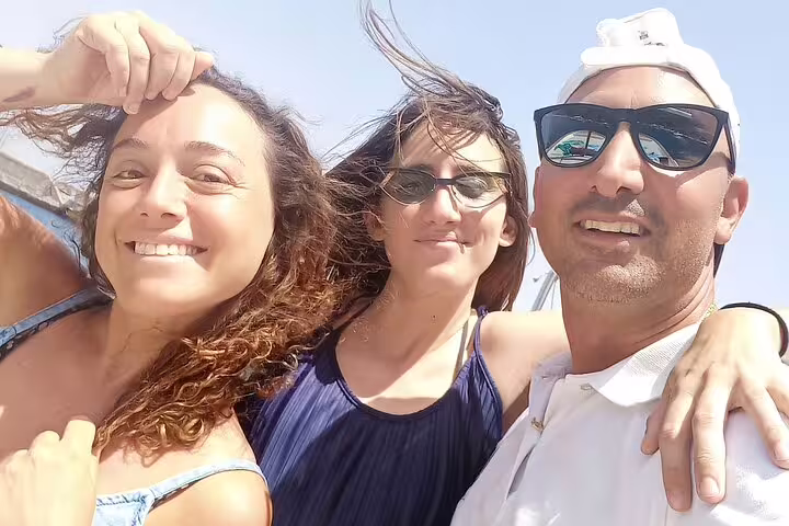 Happy guests with skipper on Capri Essence private classic boat tour, enjoying a 4-hour cruise