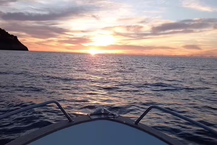 Sunset view from the bow on Capri Essence 4-hour private classic boat tour across the Tyrrhenian Sea