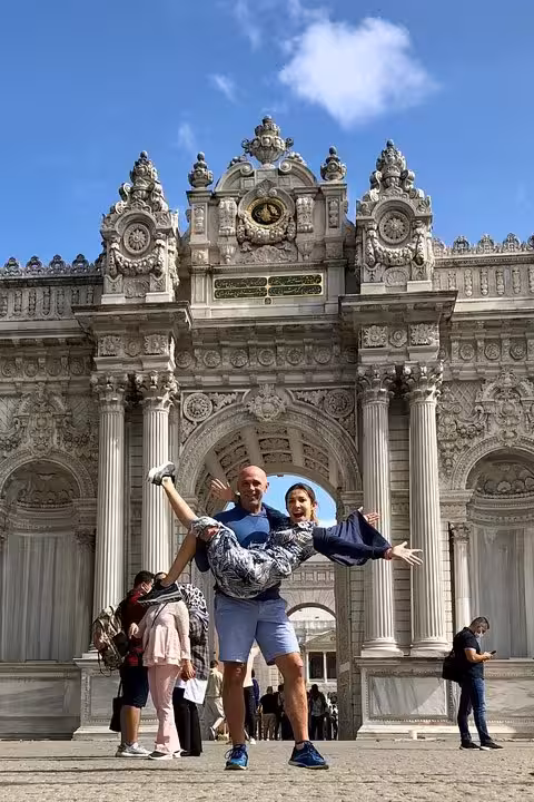 Tourists pose at ornate Dolmabahce Palace gate in Istanbul on 6-day Spanish Istanbul Cappadocia tour