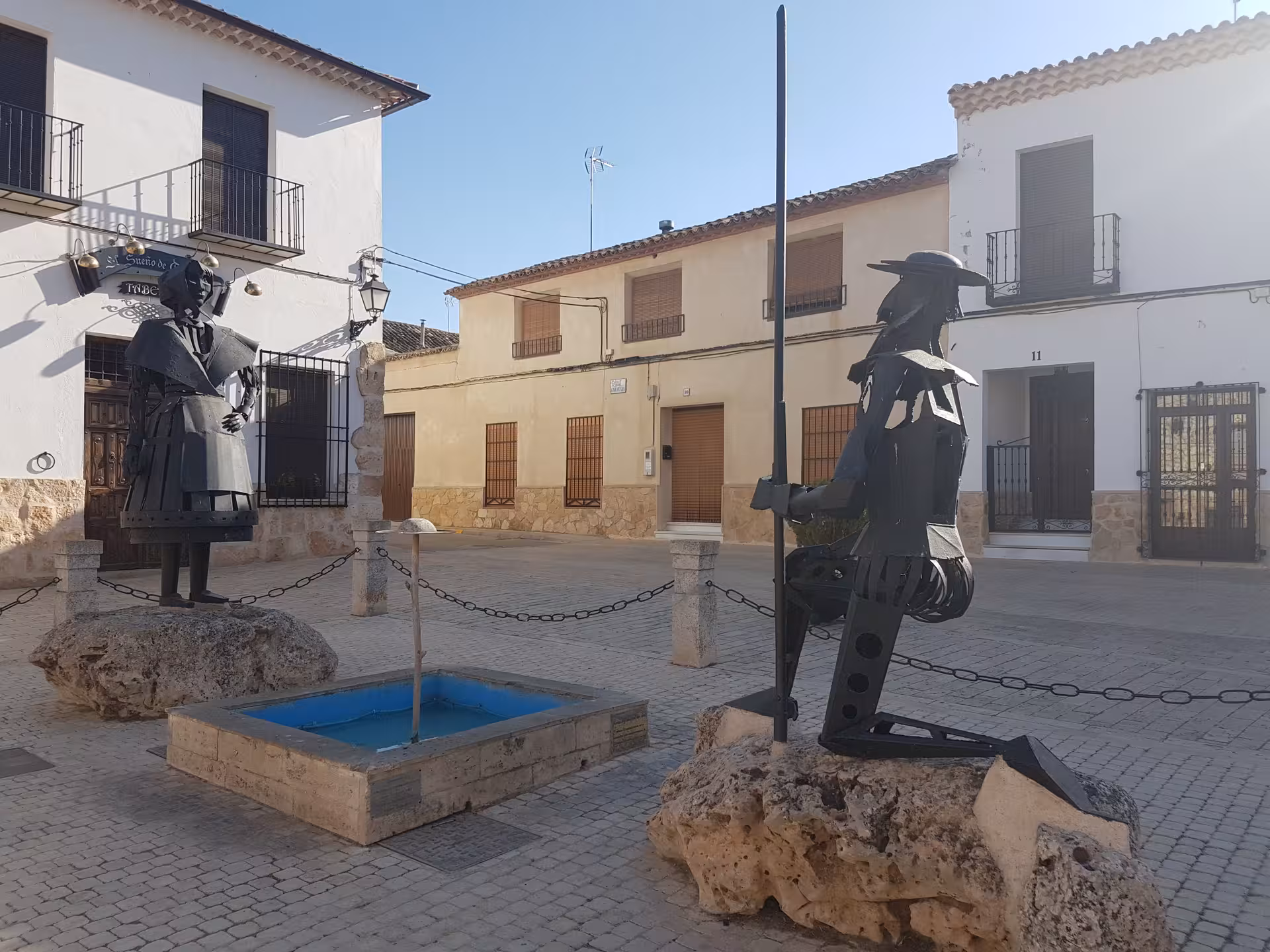 Don Quixote and Sancho Panza metal statues in a La Mancha village square, highlight of Don Quixote Tour