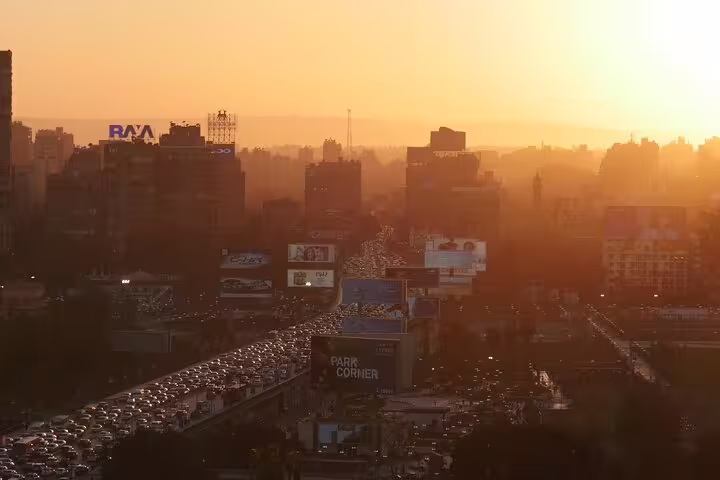 Sunset view over Downtown Cairo skyline and traffic, part of a half-day city tour with Egyptian dinner