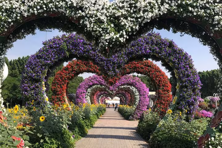 Dubai Miracle Garden ticket photo of heart-shaped floral tunnel walkway with layered arches of vibrant flowers
