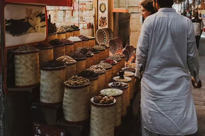 Dubai Spice Souk stall with baskets of herbs and dried fruits on a private customizable half-day tour