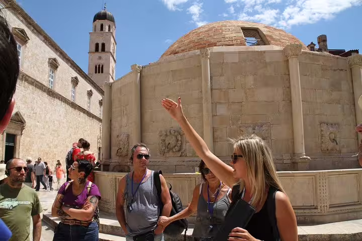 Local guide explaining Dubrovnik Old Town landmarks near Onofrio’s Fountain on private walking tour