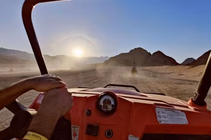 Driver view in a dune buggy at sunset in Sinai desert, guided ride from Sharm El Sheikh with pickup