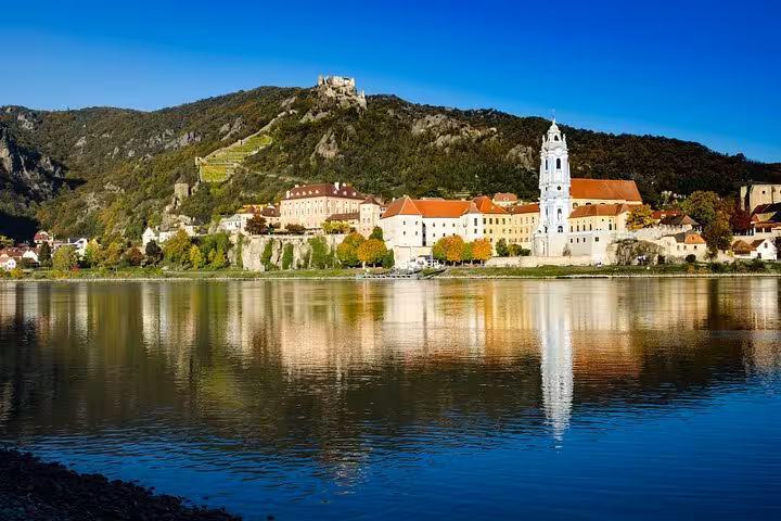 Dürnstein village and Danube River views on Wachau private tour from Vienna with vineyards and abbey tower