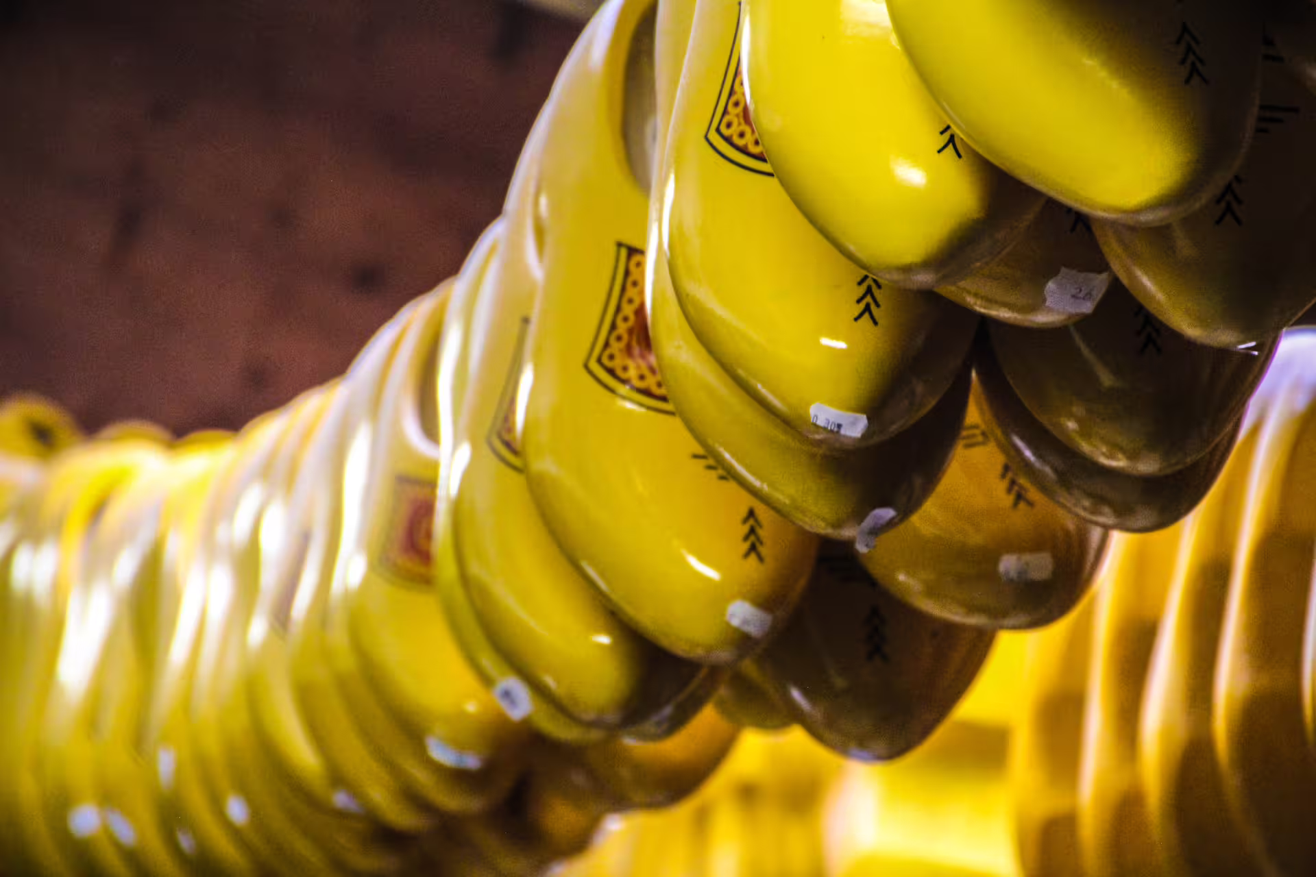 Bright yellow wooden clogs on display at a workshop in Zaanse Schans, highlighting traditional Dutch craftsmanship.