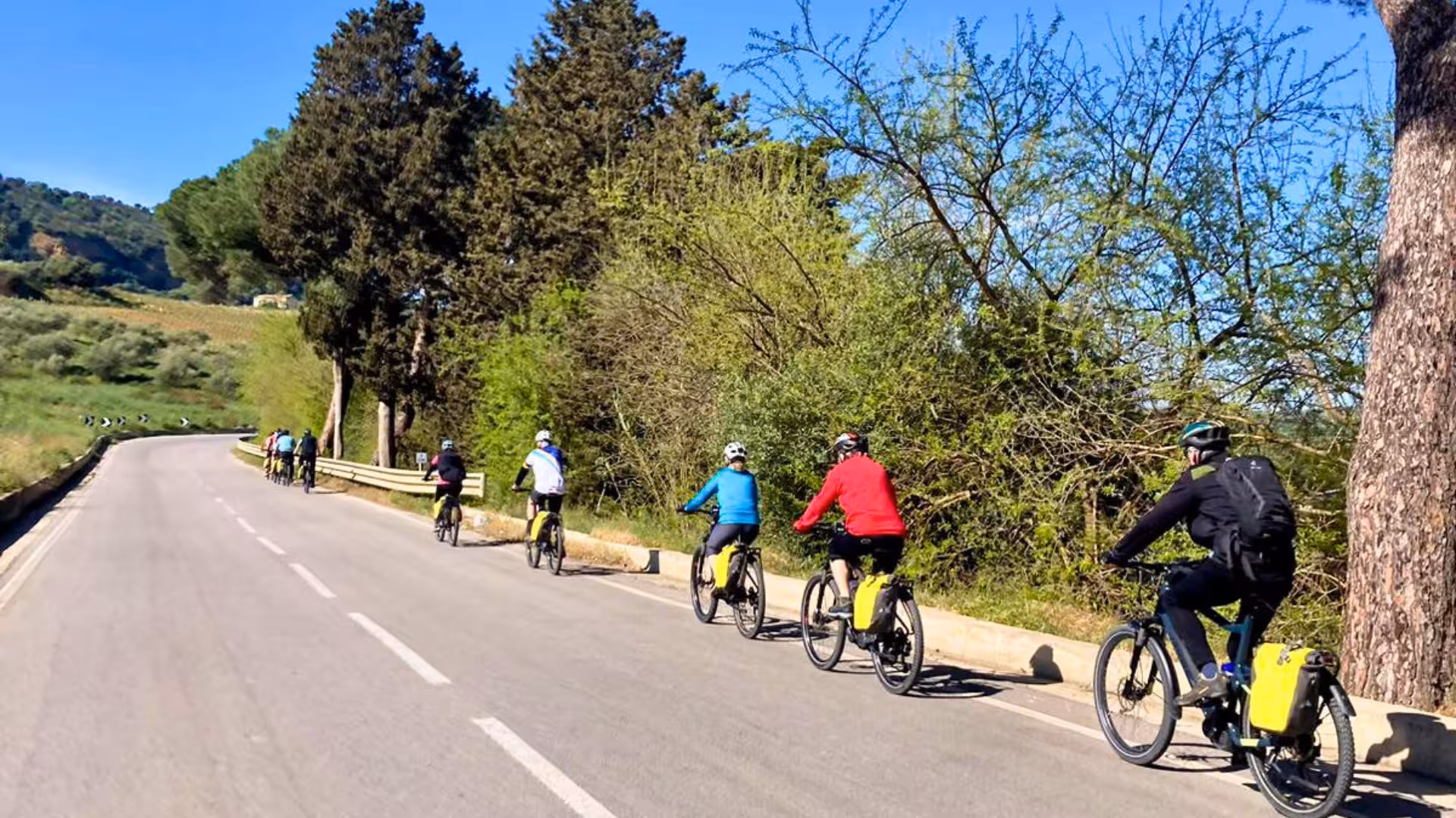 Cyclists enjoy a scenic ebike tour through lush landscapes near Castellammare del Golfo, perfect for adventure seekers.