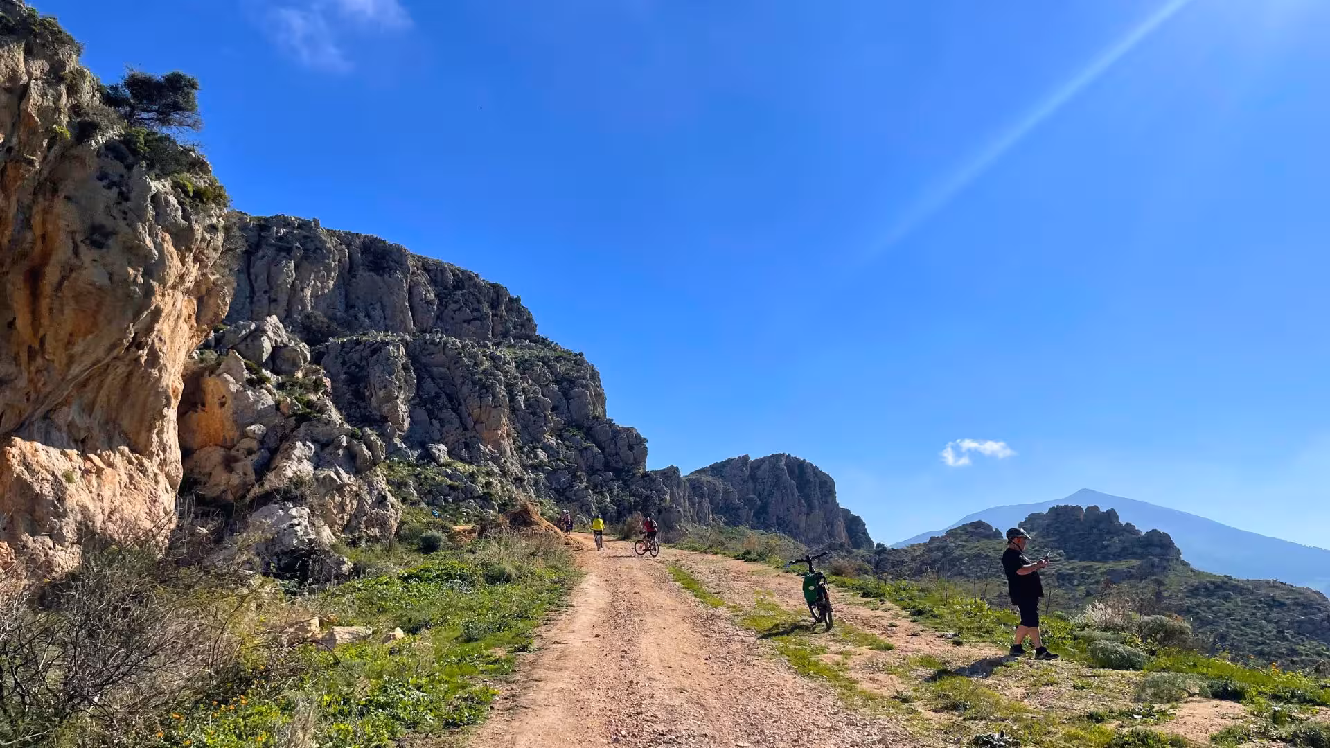 Rugged mountain landscape on the ebike tour to Grotta Mangiapane, featuring rocky paths and clear blue skies.