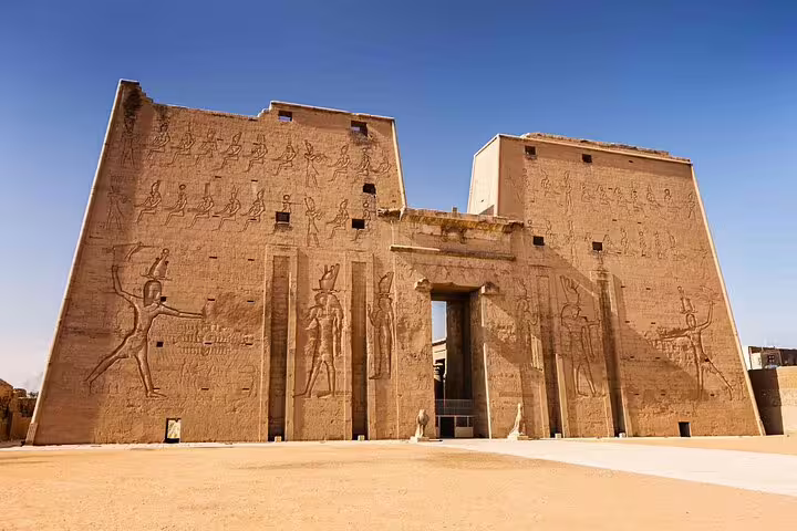 Edfu Temple pylon entrance with carved hieroglyphs, stop on Luxor to Edfu and Kom Ombo temples tour