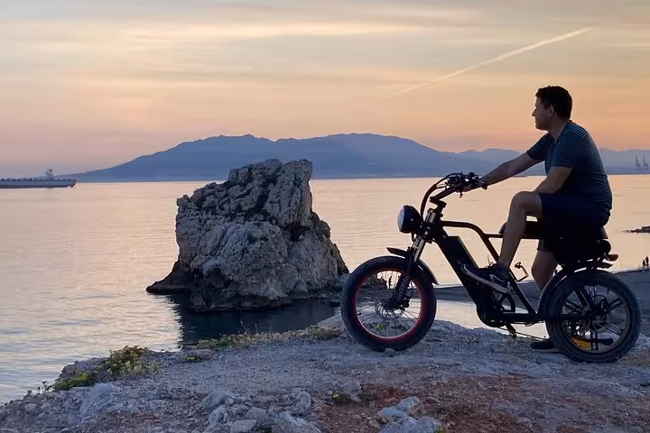Rider on e-fat bike rental at sunset on Málaga coast viewpoint, perfect for a 10-hour explore-at-your-pace tour
