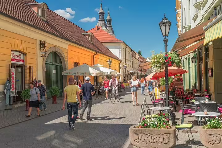 Pedestrian street in Eger old town with cafes and colorful buildings, visited on Budapest to Eger wine tour